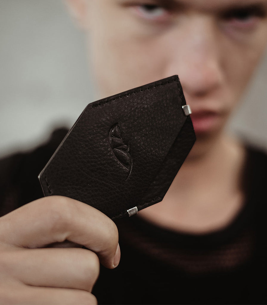 Model holding Minimalist Front pocket wallet in leather card holder from Badami & Co.